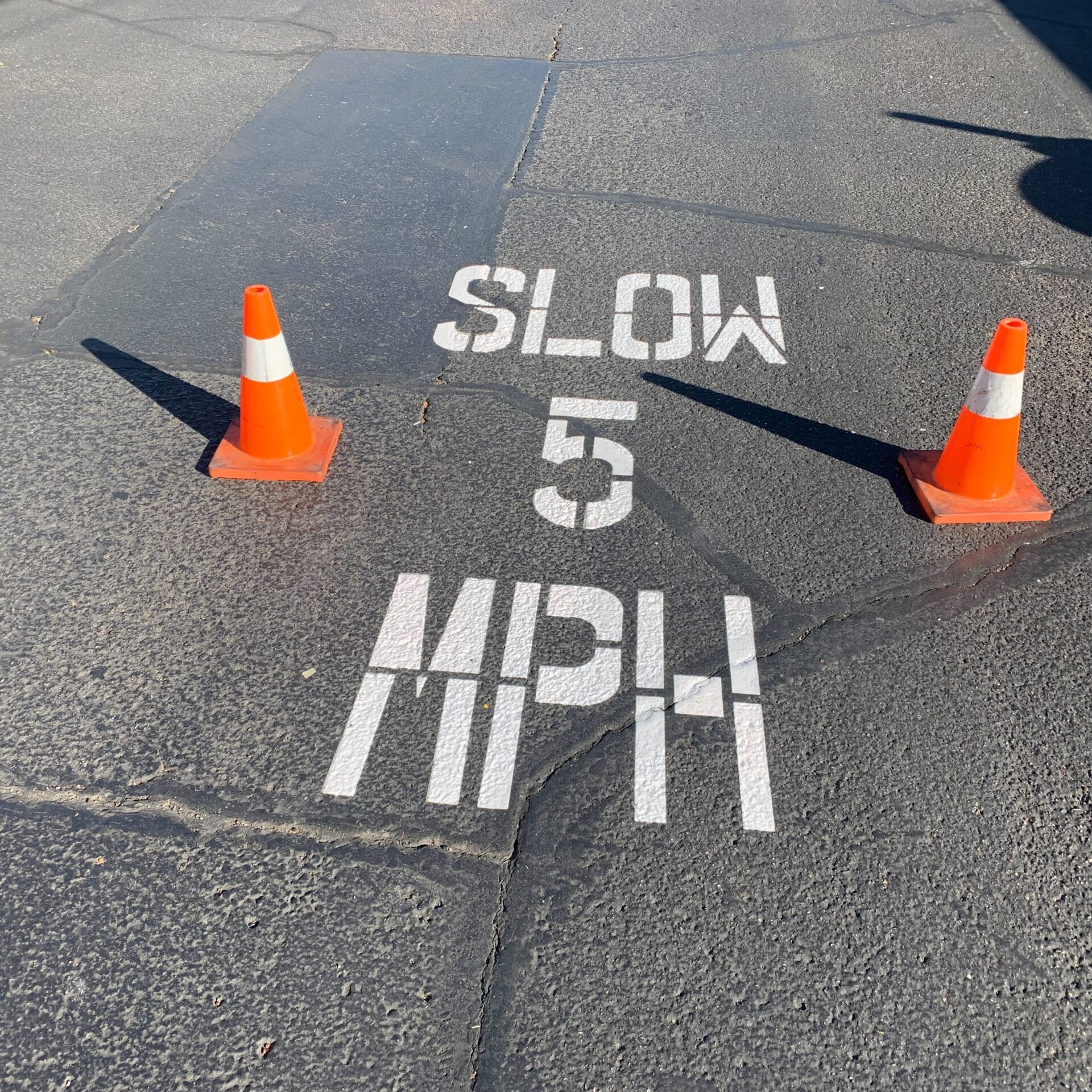 pavement speed limit stenciling markings in parking lot in Phoenix, AZ.